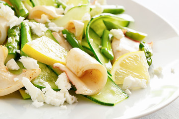 green salad with calamari, asparagus, cucumber, feta cheese, and lemon dressed with olive oil and lemon juice
