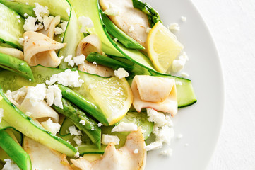 fried calamari salad with asparagus, cucumber, feta cheese, and lemon dressed with olive oil and...