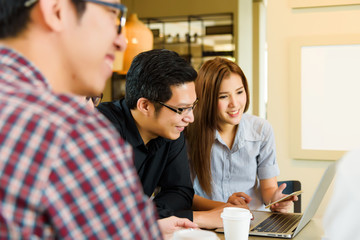 Smart handsome asian businessman or student explaining his project to colleague in casual suit at coffee shop cafe. Business and Office Concept.
