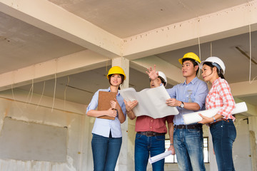 Group of Multiethnic engineers meeting about their project in construction site. Engineer...