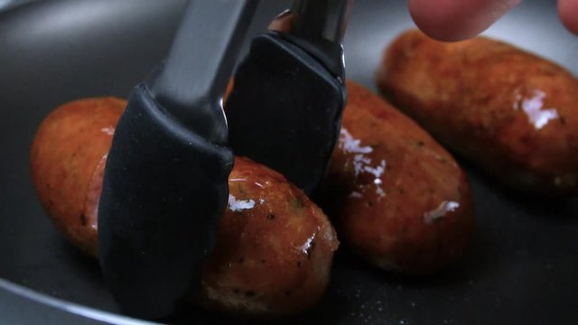 Fried sausages. The supper is ready. Grilled sausages. Slow motion.