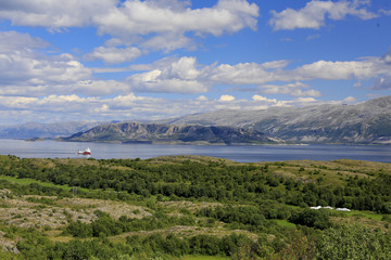 Fototapeta premium Cycling on the island of Ylvingen a great summer day, Northern Norway