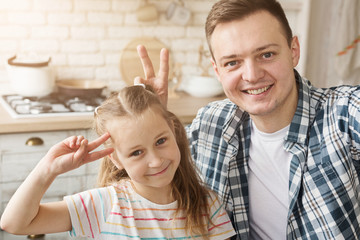 Father and daughter having fun in kitchen