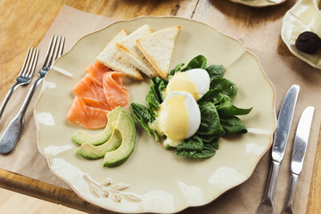 Healthy breakfast with poached eggs and smoked salm