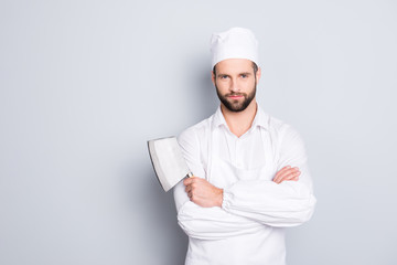 Portrait of handsome attractive butcher in beret having his arms crossed holding metal cleaver...