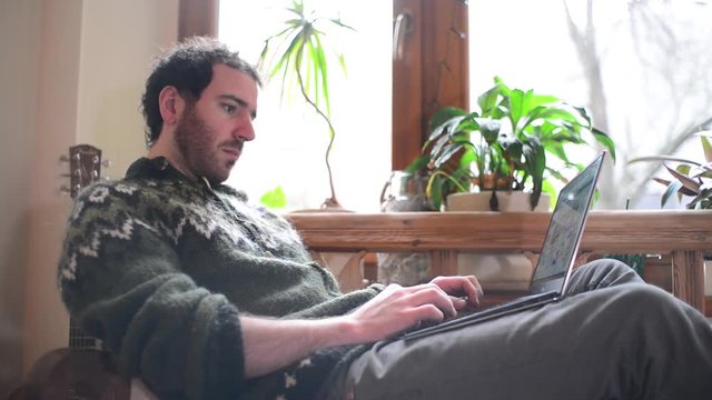 A Man use Laptop working outsource at Home near the Window - Day