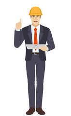 Businesswoman in construction helmet holding digital tablet PC and pointing up