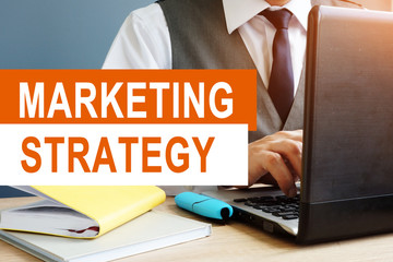 Marketing Strategy concept. Marketer working on a laptop.