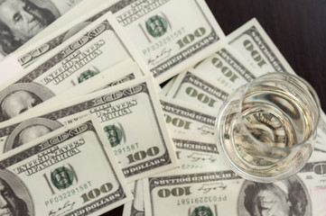 Fototapeta premium Exclusive Scott and Japanese whisky with dollars bank notes on wooden table in luxury bar, tip for good service. Film tones conception.