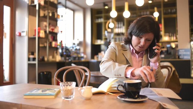 Business Woman Administrator make Notes with Pen in a Notebook planning a Week