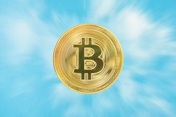 Golden spin bit coin with moving white cloud and blue sky, Digital money from the sky financial concept.