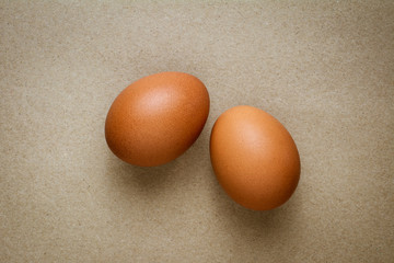 Brown chicken eggs on recycled craft paper