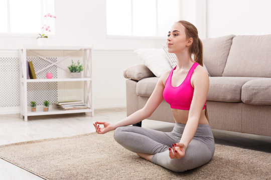 Woman training yoga in lotus pose
