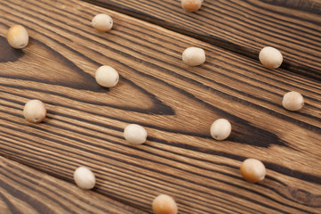 Scattered raw olives on old rustic wooden table
