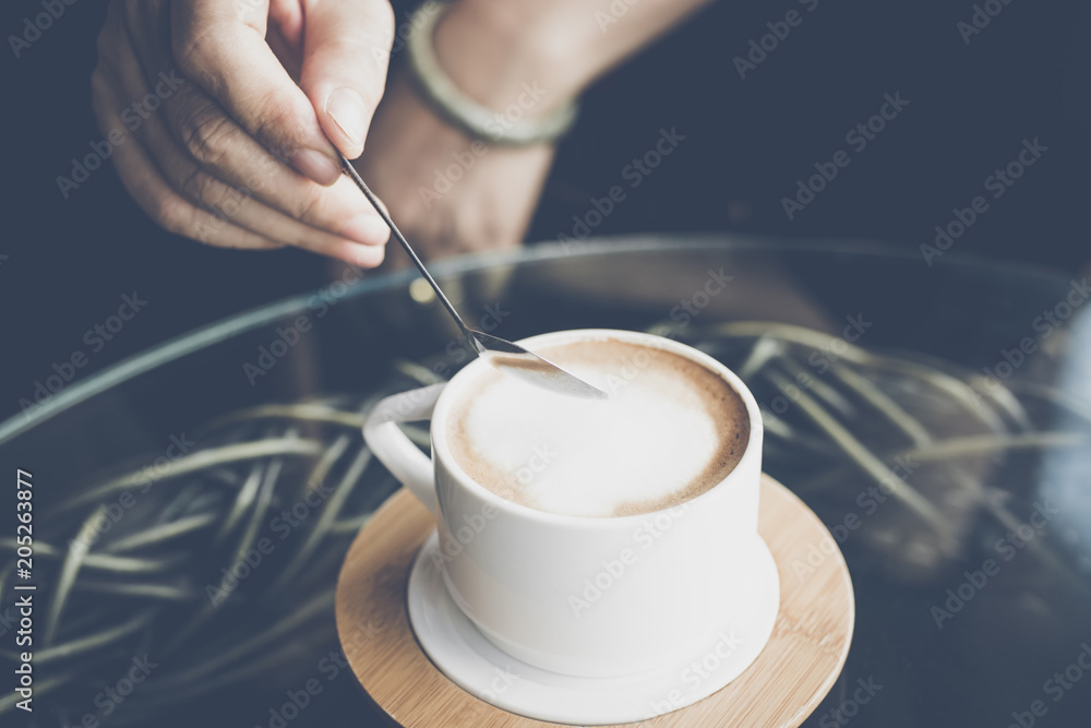 Wall mural woman hands with latte coffee on the table.