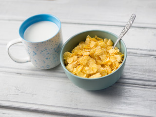 healthy corn flakes for Breakfast. Flakes with milk on white wooden background