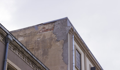 Corner shot of masonry old building under overcast sky
