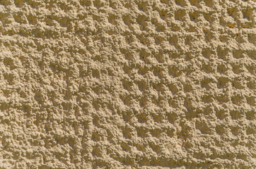 The texture of the wall under the cement plaster.