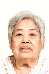 Serious looking senior woman portrait. Dramatic look. Old chinese woman.