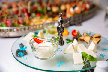 Grated parmesan cheese in glass cup.