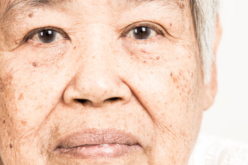 Serious looking senior woman portrait. Dramatic look. Old chinese woman.