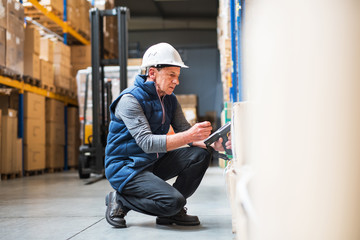Portrait of a senior male warehouse worker or a supervisor.