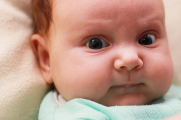 Face of the baby of the girl closeup. Cute newborn baby girl.