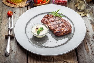 Tenderloin steak on plate with sauce