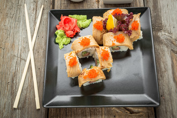 Rainbow Sushi Roll with salmon, eel, tuna, avocado, royal prawn, cream cheese Philadelphia, caviar tobica, chuka. Sushi menu. Japanese food.