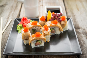 Rainbow Sushi Roll with salmon, eel, tuna, avocado, royal prawn, cream cheese Philadelphia, caviar tobica, chuka. Sushi menu. Japanese food.