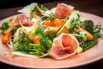 Fresh salad from vegetables, cheese and ham