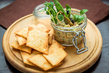 Homemade mushroom and bean paste. Pate in glass jar on rustic wooden table.