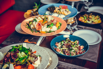 many different dishes in Restaurant, white plate on the Table with side dish,