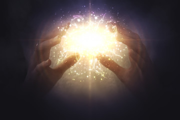 Magic in the hands. A glowing ball in the hands of a girl. Glowing particles