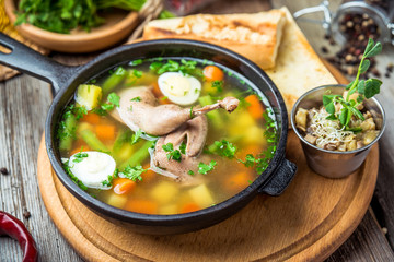 Soup with quail meat, with quail eggs and vegetables