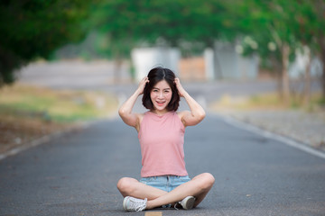 Portrait of asian woman sit on the road,Beautiful thailand people,Happy woman concept,Lifestyle of modern girl