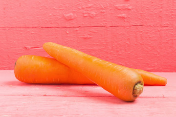 carrot on pink wood