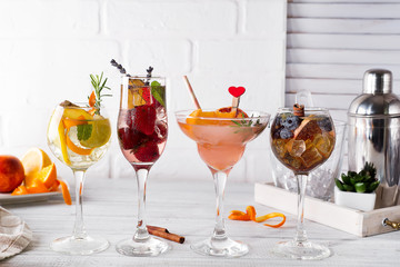 Different alcoholic drink in glass with Bar accessories on white wooden background