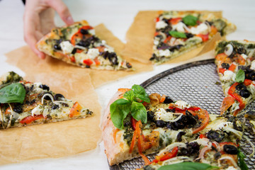 Freshly baked italian vegetarian pizza slices on a metal mesh pan