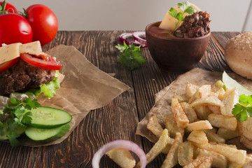 Delicious burgers with beef, tomato, cheese and lettuce
