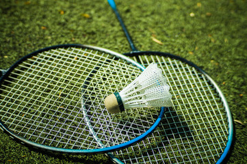 Racket and shuttlecock for playing badminton on the football field