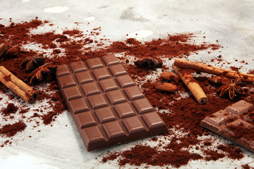 Chocolate bars on table with chocolate powder.