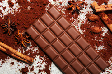 Chocolate bars on table with chocolate powder.