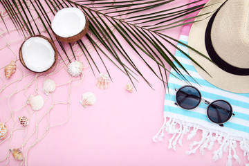 Fototapeta na wymiar Summer accessories with coconuts on pink background