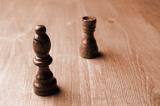 two chess pieces rook and bishop on a wooden unplaced