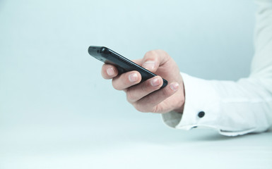 Businessman using black mobile phone.