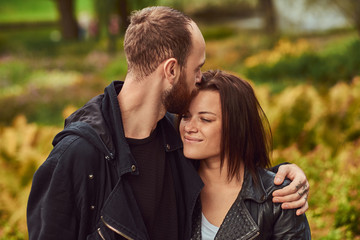 Happy modern couple in a park. Enjoying their love and nature.