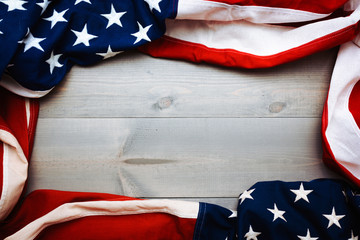 The flag of the United Sates of America on a grey plank background with copy space