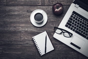 keyboard with cup of coffee on table