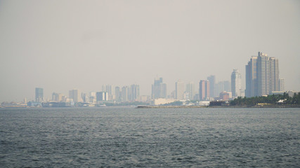 Naklejka premium Panorama Manila city, skyscrapers and buildings. Seascape coastal city of Manila. Modern city by sea. Makati district. Travel concept.